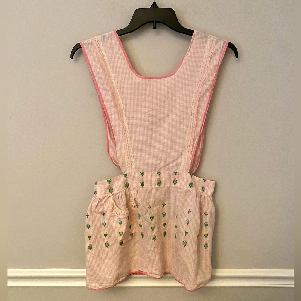 Pink embroidered flowers smocked apron top.